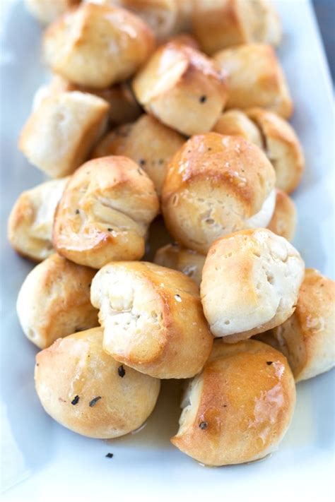 Bread bites - In a large mixing bowl, combine warm water, yeast, and sugar. Allow to stand for 10 minutes or until bubbly. While the yeast is getting bubbly, combine 2 cups of the flour, salt, 1 1/2 tablespoons rosemary, oregano and garlic powder. Add flour mixture to yeast mixture along with 1 tablespoon of olive oil. Mix well.